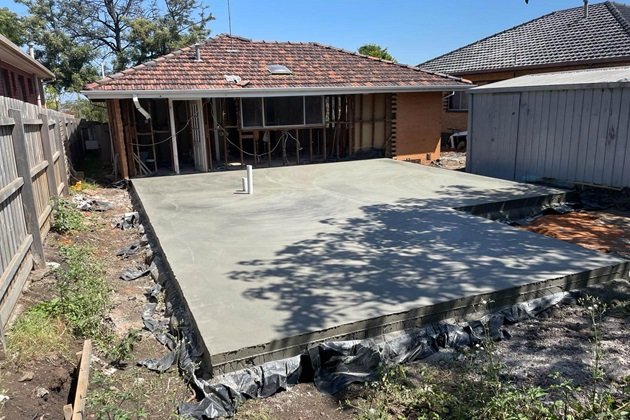 Concrete slab during the curing process, covered with protective sheeting