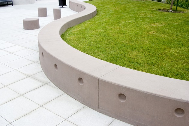 Curved concrete retaining wall following natural landscape contours