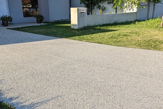 Winding garden path made of exposed aggregate concrete with multi-coloured stones