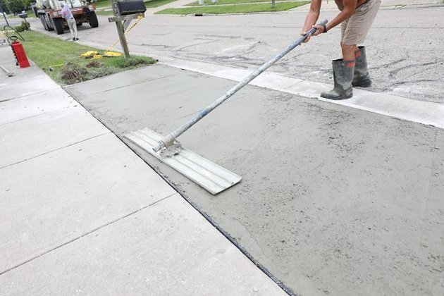 Repair work being done on an exposed aggregate concrete driveway